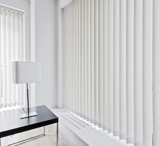 vertical fabric blinds on floor to ceiling windows